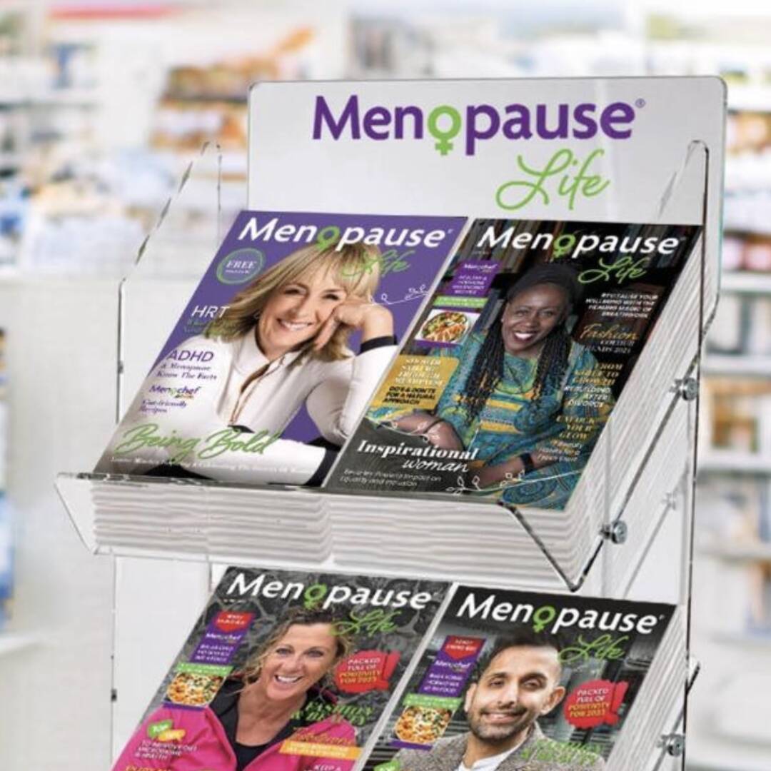 A woman reading Menopause Life magazine in a waiting area.